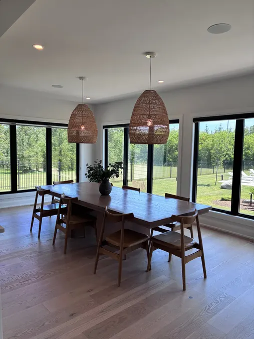 Dining room with a wood table and large windows